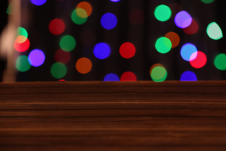 Closeup view of wooden table with glowing lightsの写真素材
