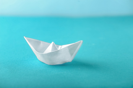 Origami boat on color backgroundの写真素材