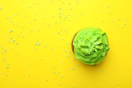 Delicious cupcake on color backgroundの写真素材