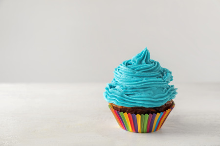 Delicious cupcake on white table