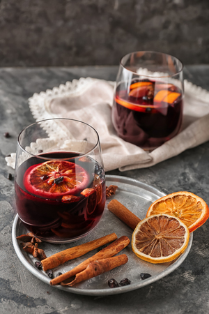 Glass of delicious mulled wine on metal trayの写真素材