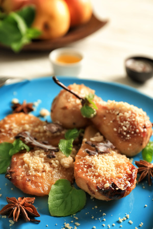 Baked pears with nuts on plate, closeupの写真素材