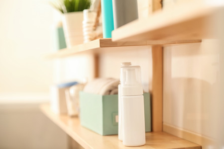 Body care accessories on shelf in bathroom