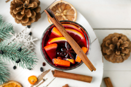 Glass of delicious mulled wine on white boardの写真素材