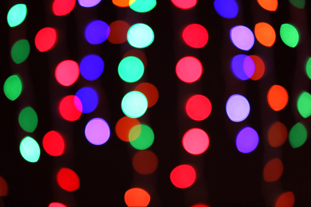 Blurred view of glowing lights on dark backgroundの写真素材