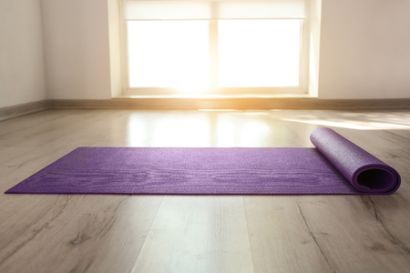 Yoga mat on floor indoorsの写真素材