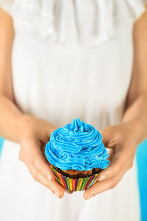 Woman holding tasty cupcake, closeupの写真素材