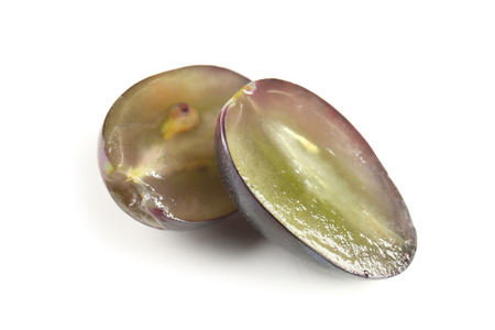 Halves of ripe sweet grape on white backgroundの写真素材