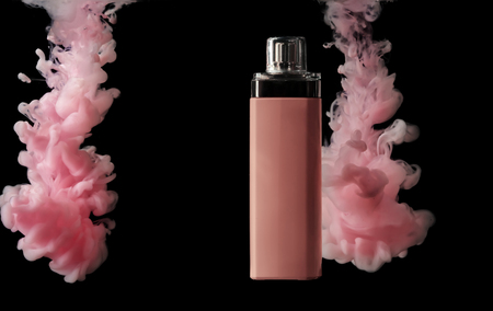 Bottle of perfume in color smoke on dark backgroundの写真素材