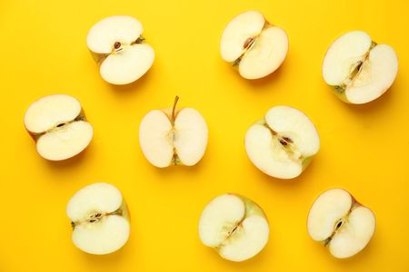 Cut fresh apples on color backgroundの写真素材