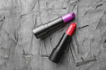 Lipsticks of different shades on grey backgroundの写真素材