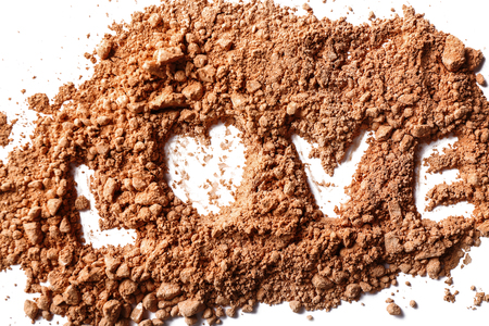 Cacao powder with word LOVE on white backgroundの写真素材