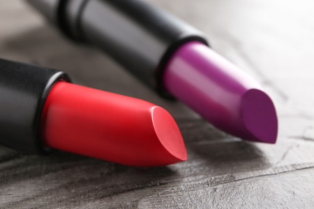 Lipsticks of different shades on grey background, closeupの写真素材