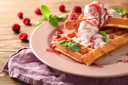 Delicious waffles with berry jam and ice cream on plateの写真素材
