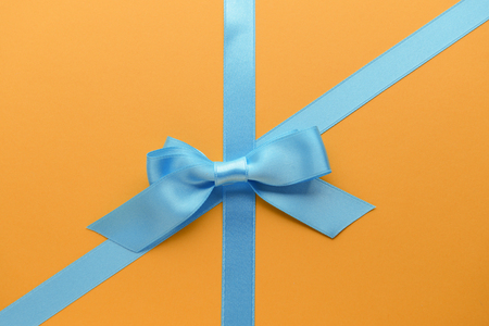 Blue ribbons with bow on color backgroundの写真素材