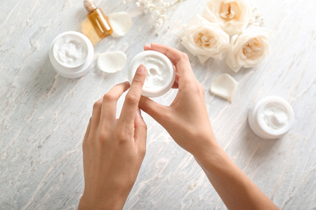 Young woman applying body cream, closeupの写真素材