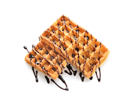 Delicious waffles with chocolate sauce on white backgroundの写真素材