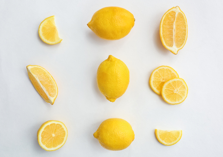 Flat lay composition with ripe juicy lemons on white background