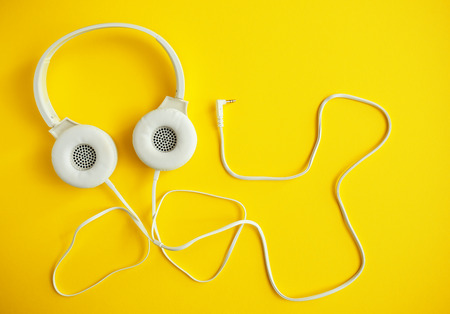 Modern headphones on color backgroundの写真素材