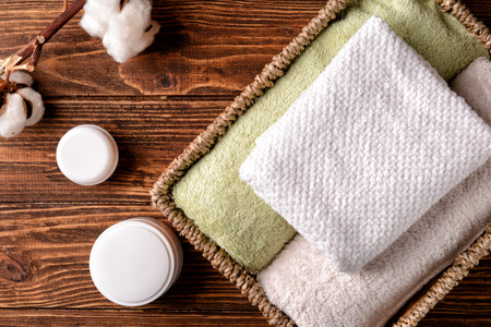 Flat lay composition with clean soft towels on wooden background