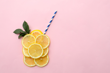 Flat lay composition with lemon slices and straw on color backgroundの写真素材