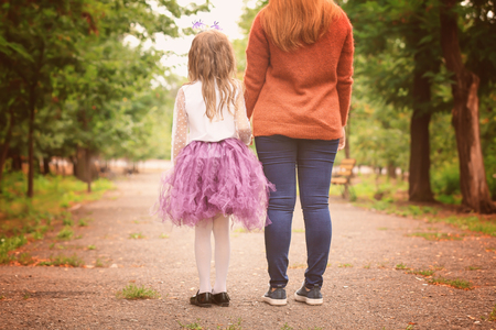 Cute little girl in Halloween costume and her mother outdoorsの写真素材