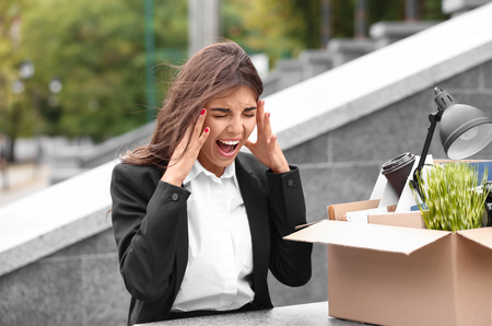 Fired stressed worker with personal stuff outdoorsの写真素材