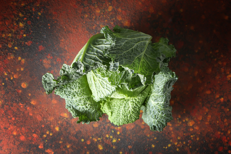 Fresh savoy cabbage on color tableの写真素材