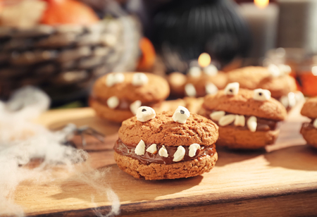 Creative cookies prepared for Halloween party on wooden boardの写真素材