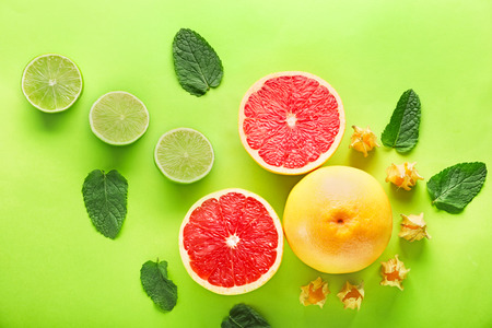 Summer composition with tropical fruits on color backgroundの写真素材