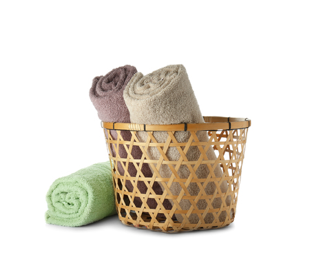 Basket with clean soft towels on white backgroundの写真素材