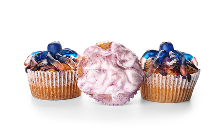 Creative cupcakes prepared for Halloween party on white backgroundの写真素材