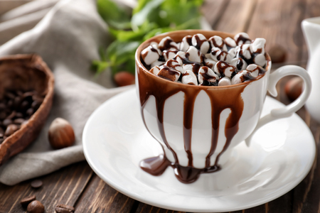 Cup of hot chocolate with marshmallows on wooden tableの写真素材