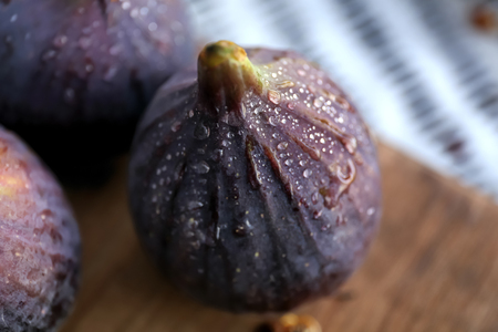 Fresh ripe figs on wooden board, closeup