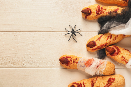 Creative cookies prepared for Halloween party on white wooden tableの写真素材