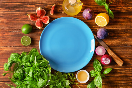 Composition with plate and ingredients for fig salad on wooden backgroundの写真素材