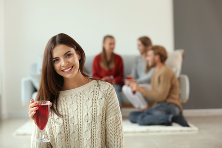 Woman with delicious mulled wine at partyの写真素材