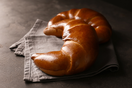 Tasty fresh crescent rolls on grey tableの写真素材