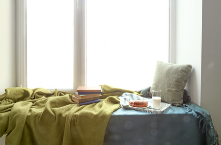 Cozy place for rest with books and tasty breakfast on windowsillの写真素材