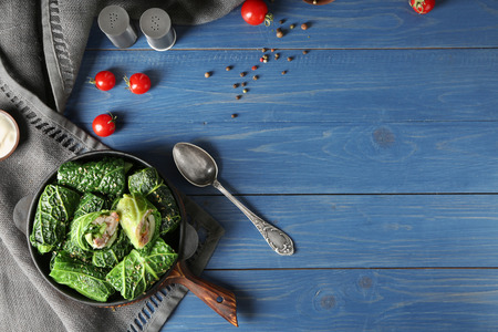 Pan with stuffed cabbage leaves on wooden tableの写真素材