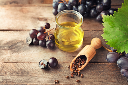 Composition with grape seed oil on wooden backgroundの写真素材