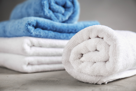 Rolled clean towel on table, closeupの写真素材