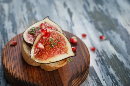 Tasty sandwich with ripe fig on wooden boardの写真素材