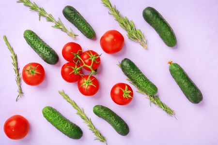 Flat lay composition with fresh vegetables and rosemary on color background
