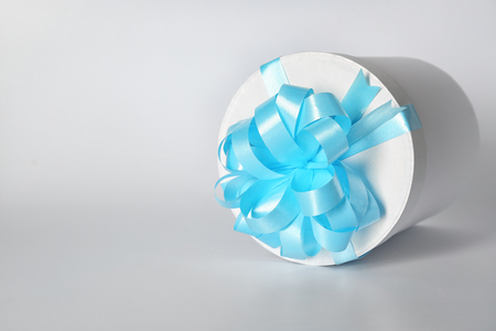 Gift box with blue ribbon on white backgroundの写真素材
