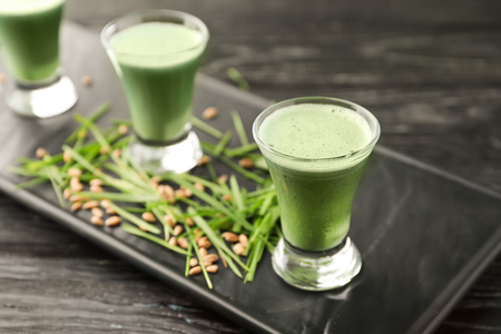 Shots of healthy wheat grass juice on plateの写真素材