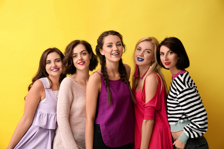 Portrait of beautiful women on color backgroundの写真素材