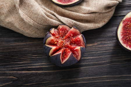 Cut ripe figs on wooden tableの写真素材