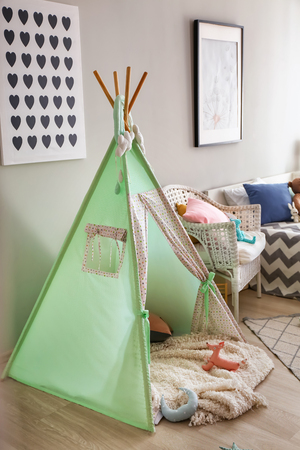 Cozy play tent for kids in interior of roomの写真素材