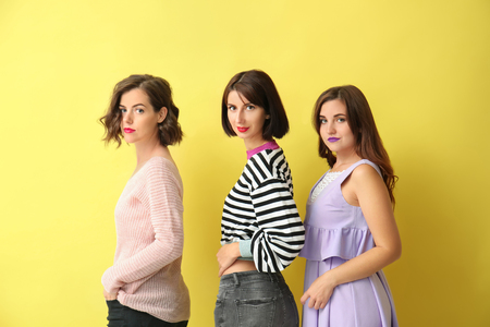 Portrait of beautiful women on color backgroundの写真素材